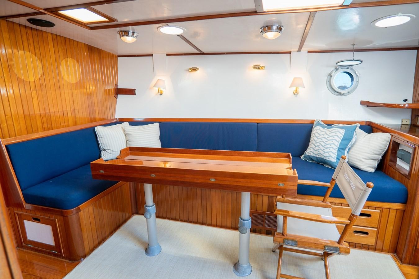 a room with a couch and a table aboard PIAFFE Yacht for Sale