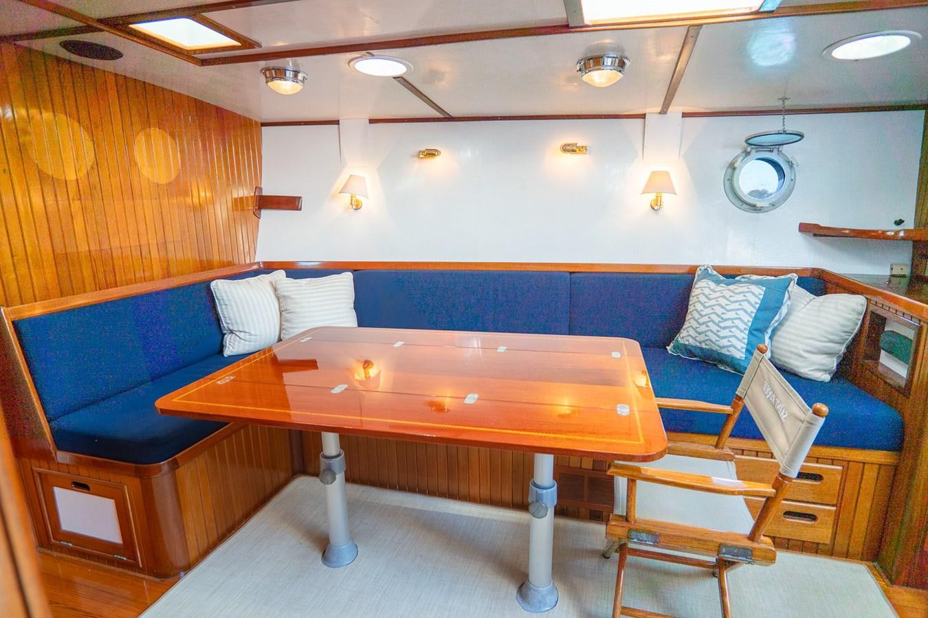 a room with a table and chairs aboard PIAFFE Yacht for Sale
