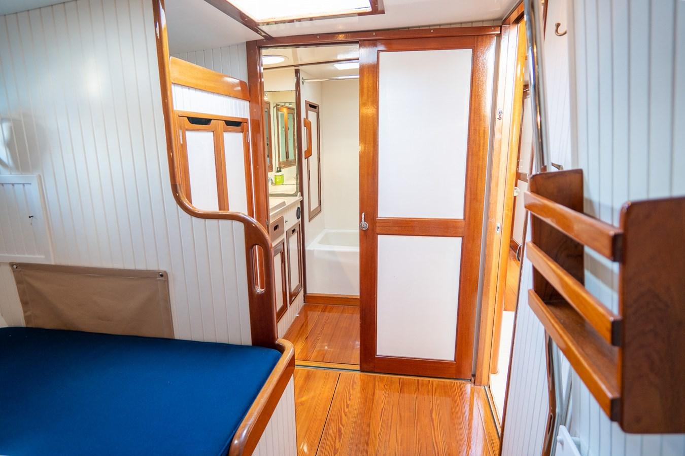 a room with a bed and a closet aboard PIAFFE Yacht for Sale