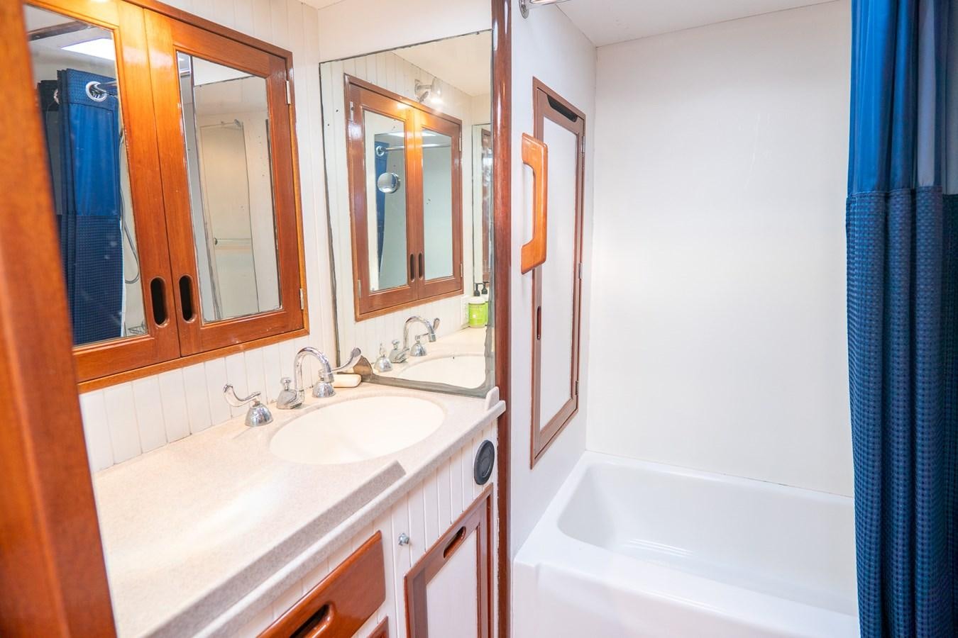 a bathroom with a sink and a bathtub aboard PIAFFE Yacht for Sale