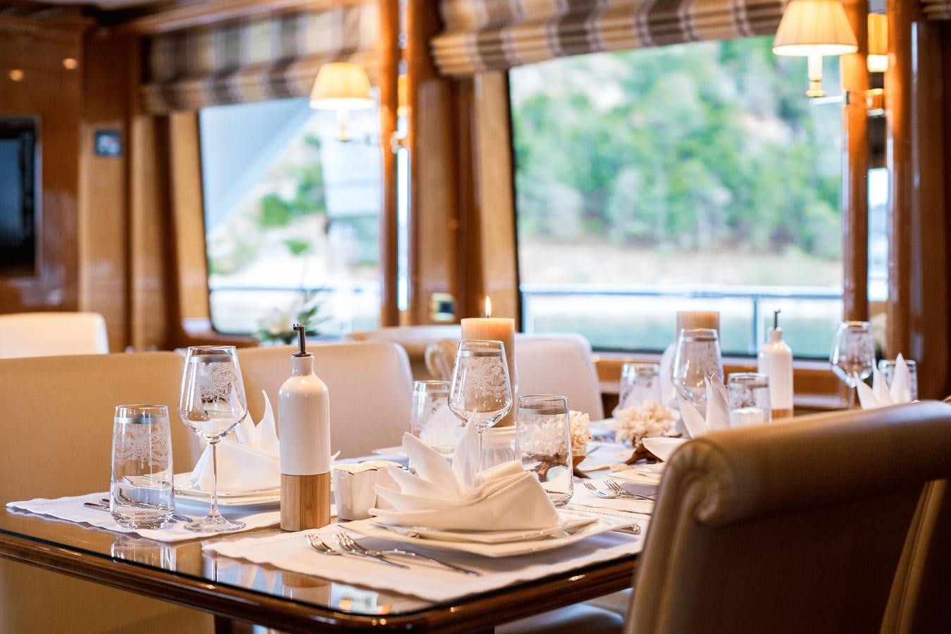 a table with wine glasses and bottles aboard REBECCA V Yacht for Sale