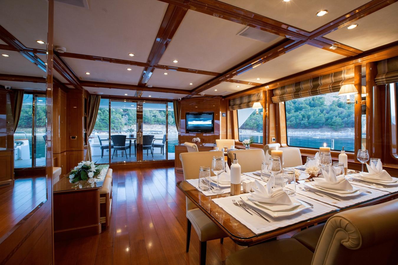 a room with tables and chairs aboard REBECCA V Yacht for Sale