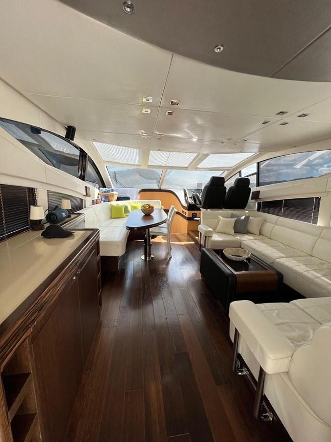 a room with a couch and a table and chairs aboard ESCAPE Yacht for Sale