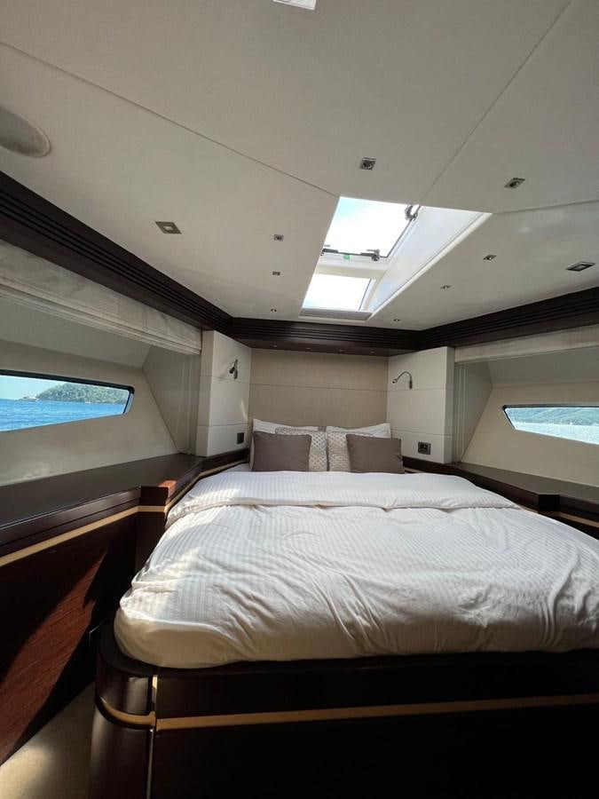a room with a bed and a window aboard ESCAPE Yacht for Sale