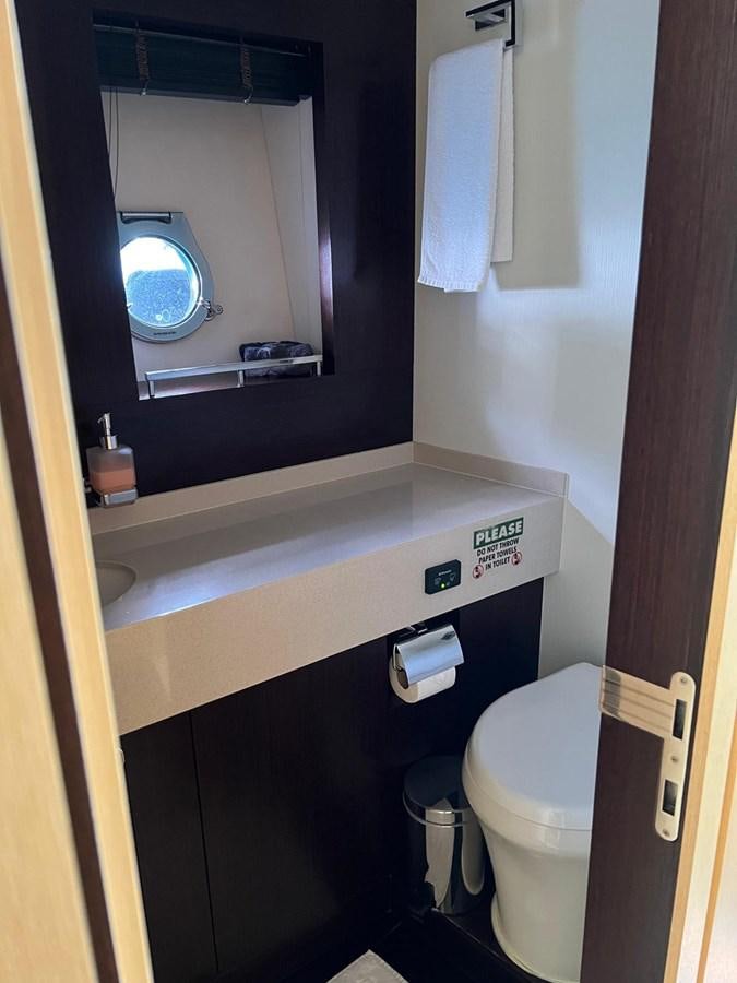 a bathroom with a sink and a toilet aboard ESCAPE Yacht for Sale