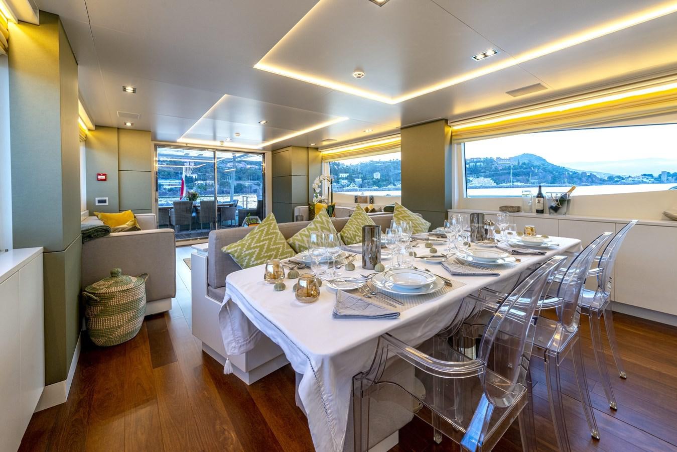 a dining room with white tables and chairs aboard MANATEA Yacht for Sale