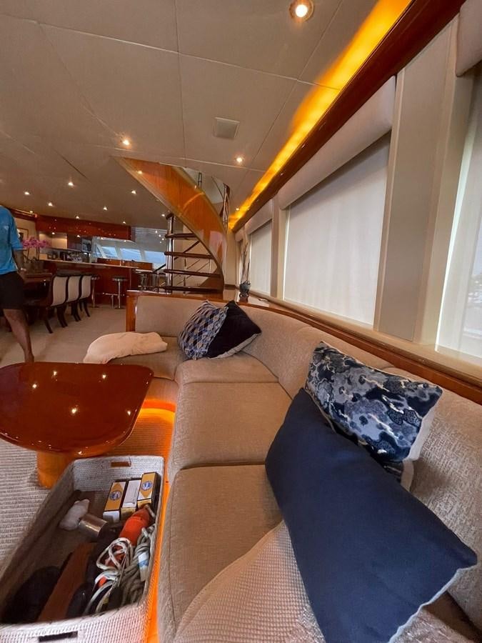 a living room with a couch and a staircase aboard GAVIOTA III Yacht for Sale