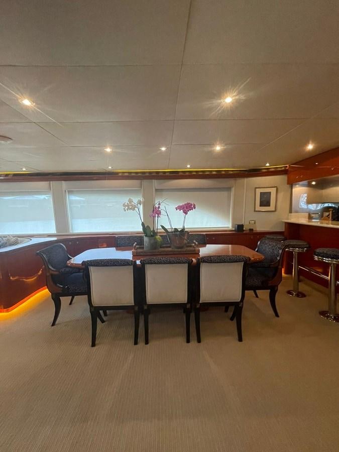 a room with a table and chairs aboard GAVIOTA III Yacht for Sale