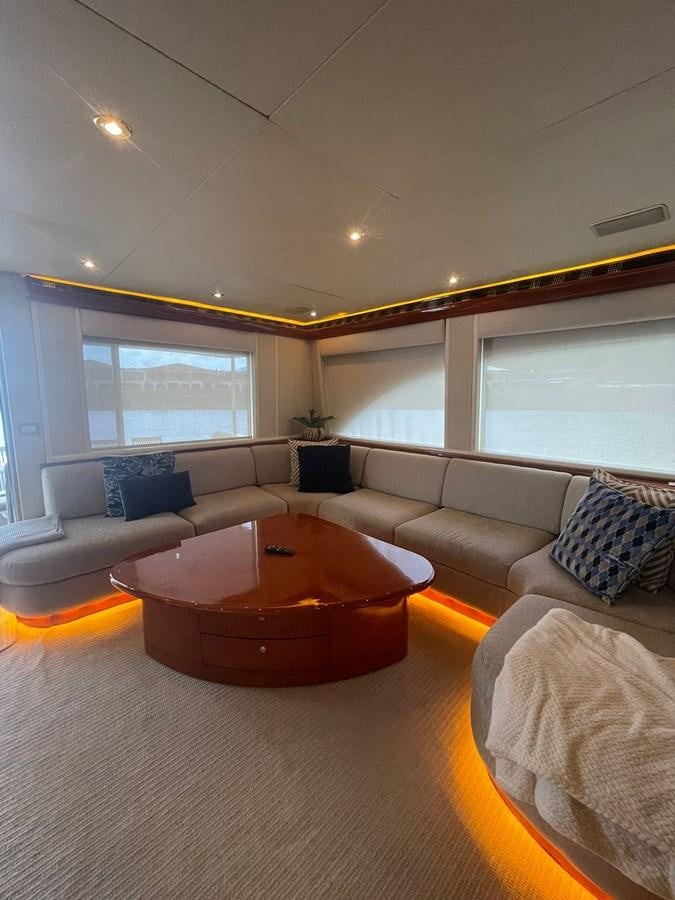 a living room with a table and couches aboard GAVIOTA III Yacht for Sale