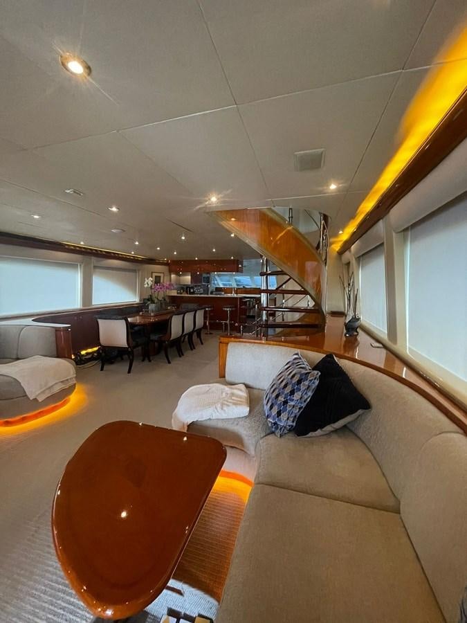a living room with a staircase aboard GAVIOTA III Yacht for Sale