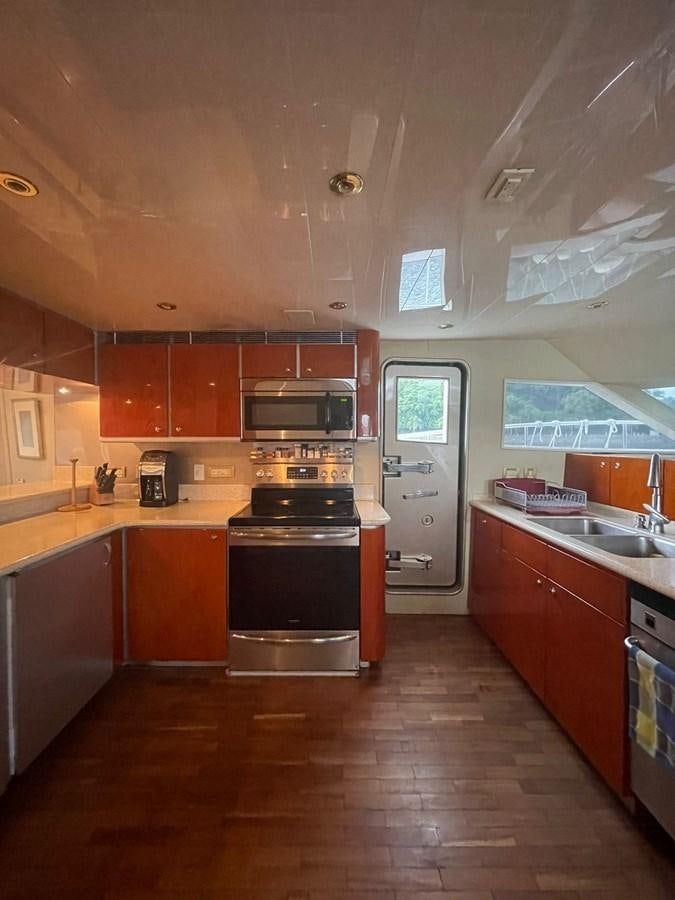a kitchen with wooden cabinets aboard GAVIOTA III Yacht for Sale