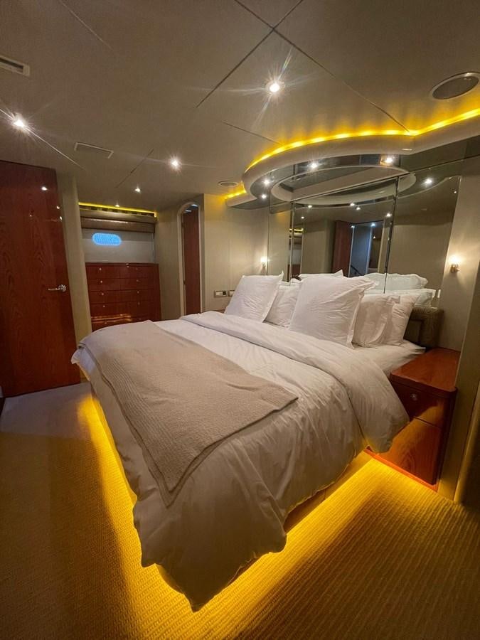 a bed with a white bed spread aboard GAVIOTA III Yacht for Sale