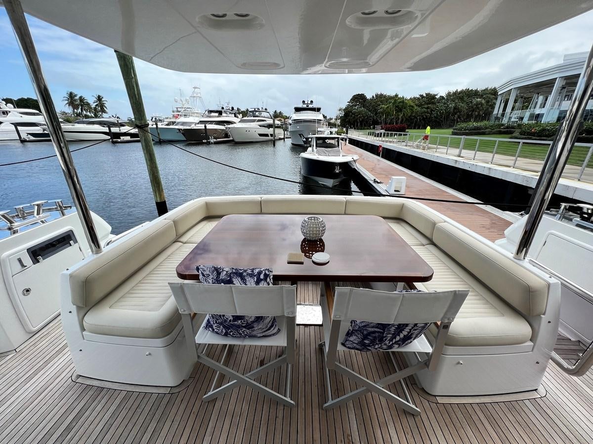 a table and chairs on a deck aboard PURA VIDA Yacht for Sale