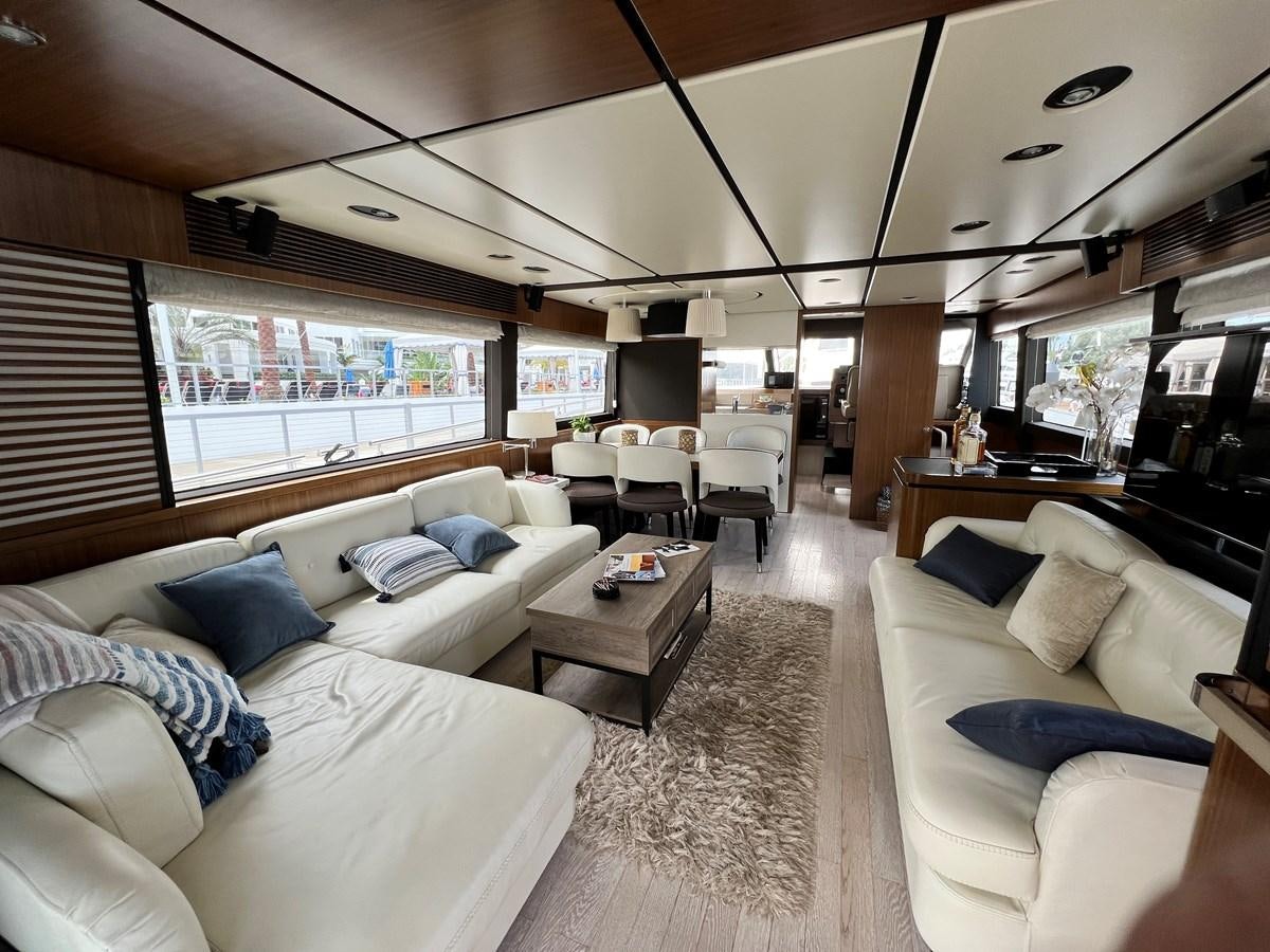 a living room with a couch and a table aboard PURA VIDA Yacht for Sale