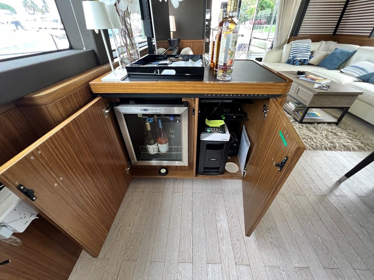 a room with a bed and a television aboard PURA VIDA Yacht for Sale