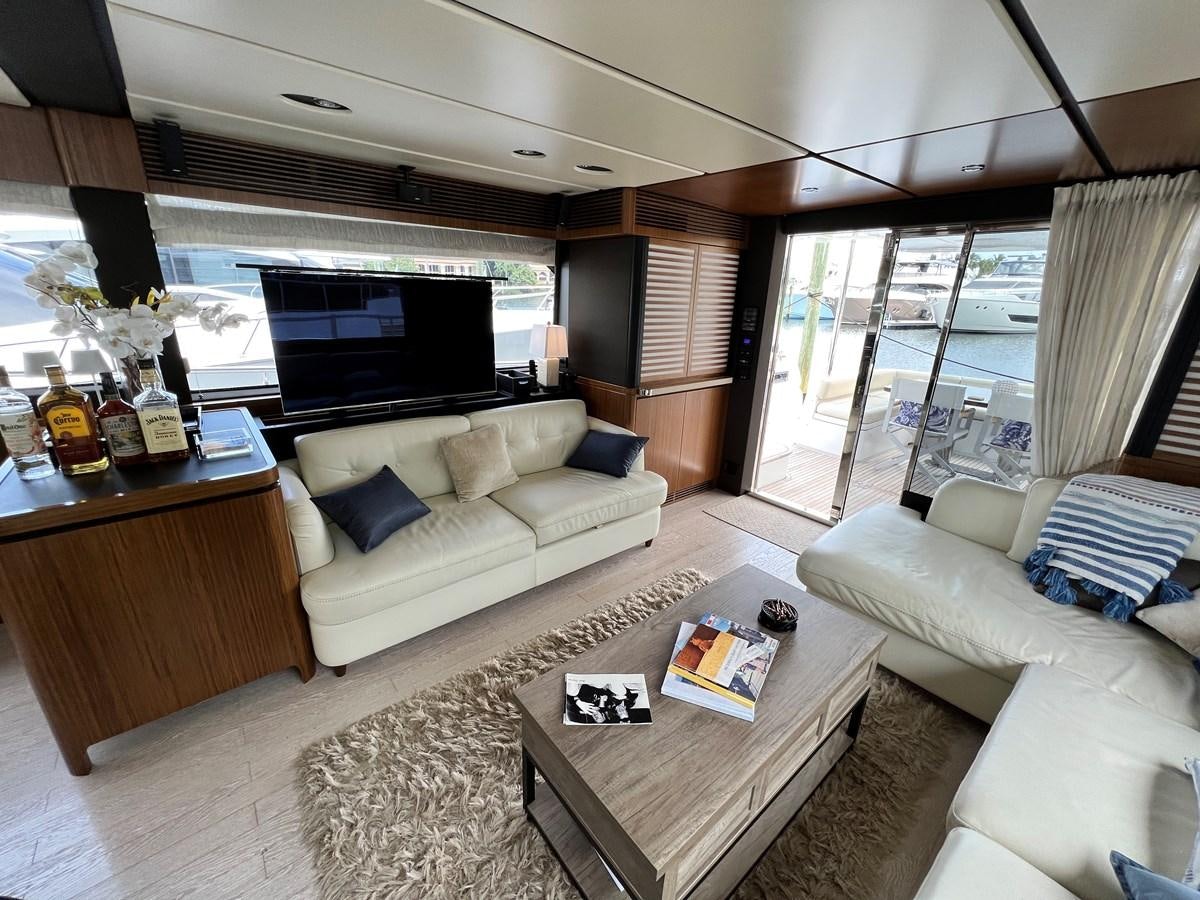 a living room with a large window aboard PURA VIDA Yacht for Sale