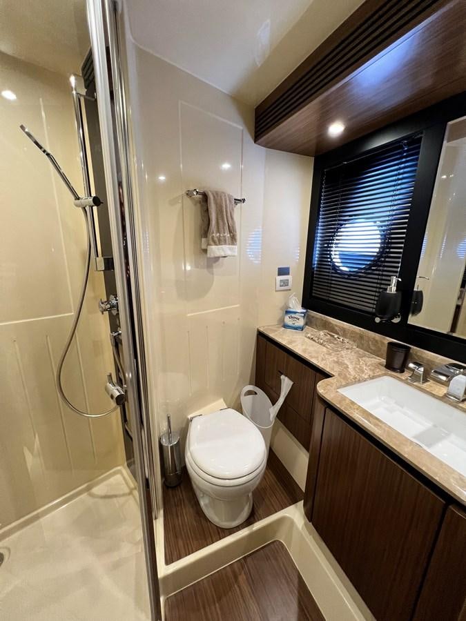 a bathroom with a glass shower door aboard PURA VIDA Yacht for Sale