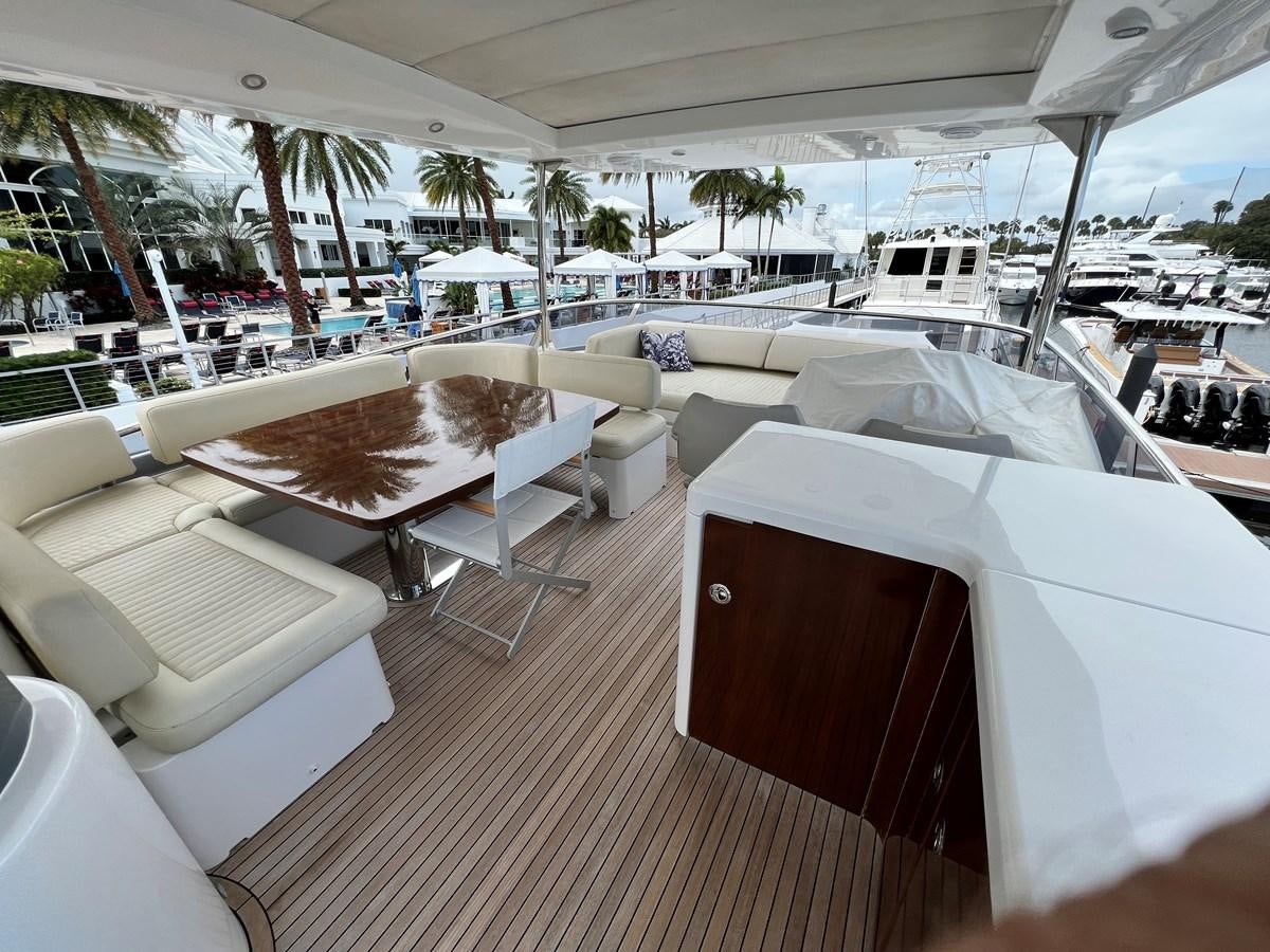 a boat with lounge chairs and umbrellas on a deck aboard PURA VIDA Yacht for Sale