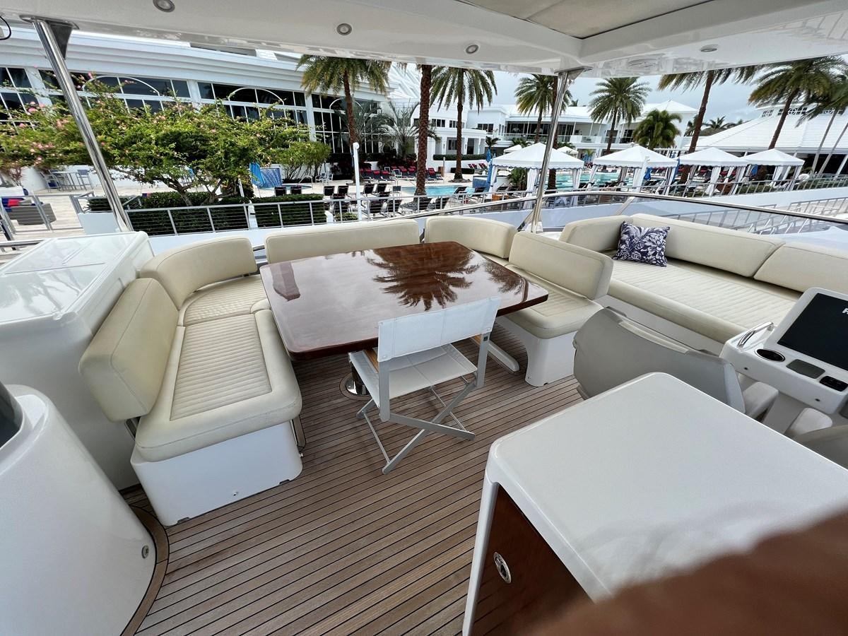 a room with tables and chairs aboard PURA VIDA Yacht for Sale