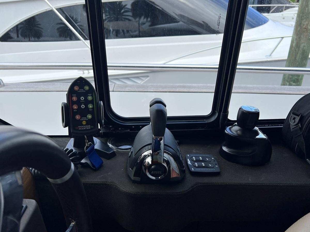 a seat with a microphone and a speaker on it aboard PURA VIDA Yacht for Sale