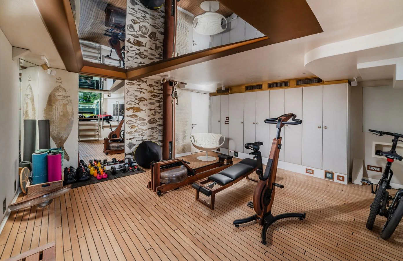 a room with a wood floor and a large fireplace aboard JOY ME Yacht for Sale