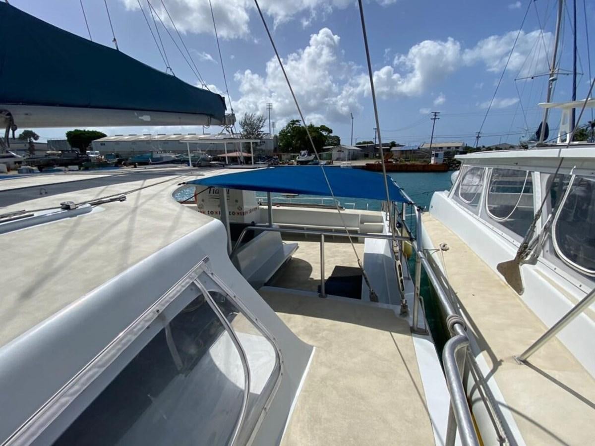 a deck with a boat and a pool aboard 1996 GOLD COAST GC 70 Yacht for Sale