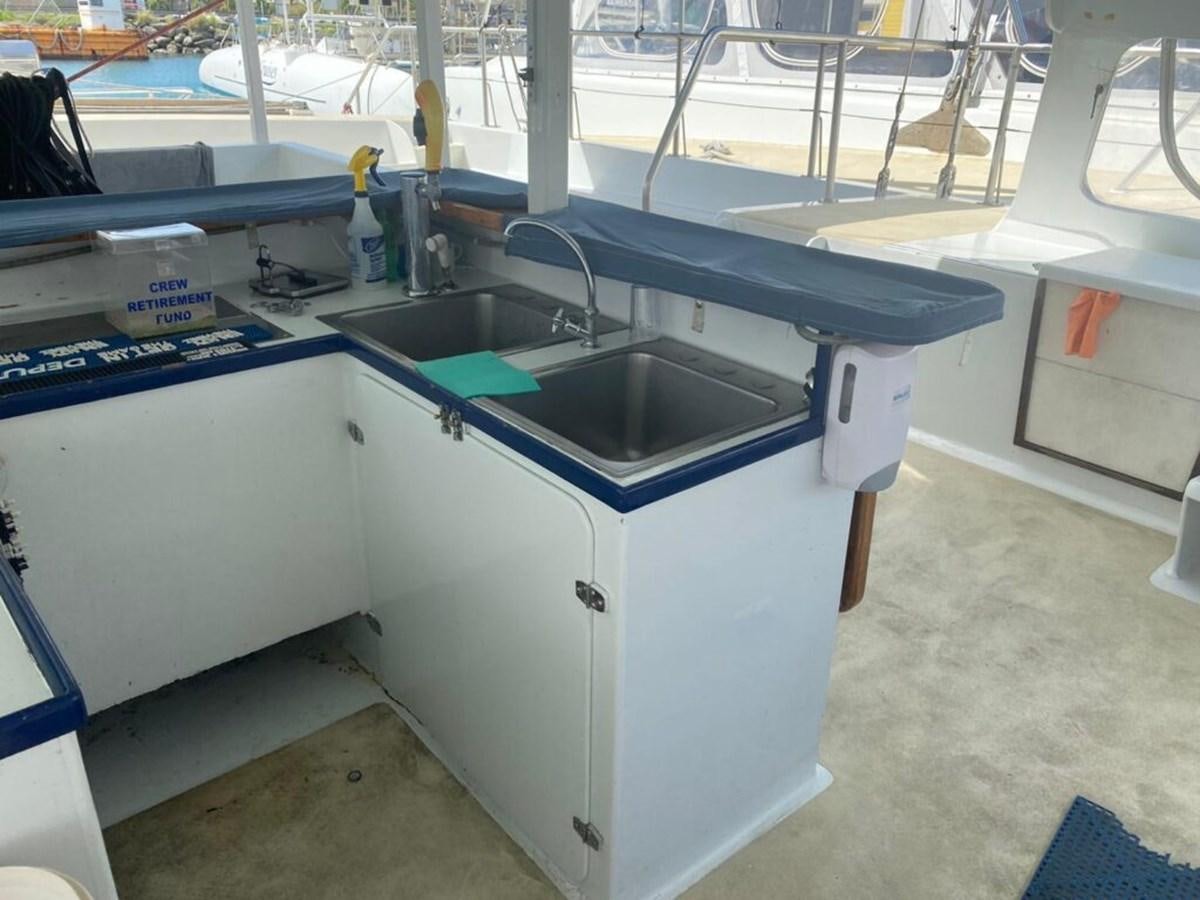 a kitchen with a sink and a large window aboard 1996 GOLD COAST GC 70 Yacht for Sale