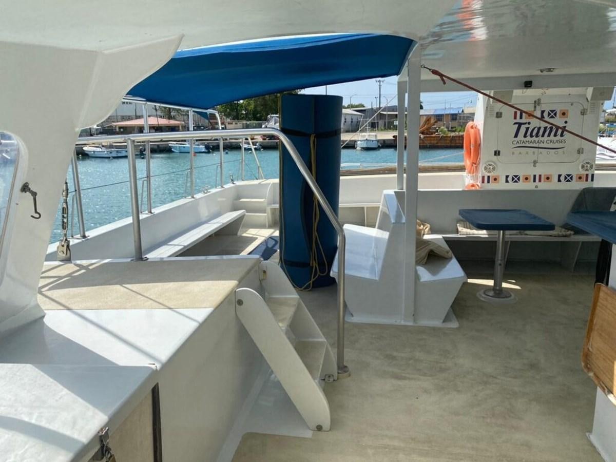 a boat with a chair and a table on the deck aboard 1996 GOLD COAST GC 70 Yacht for Sale