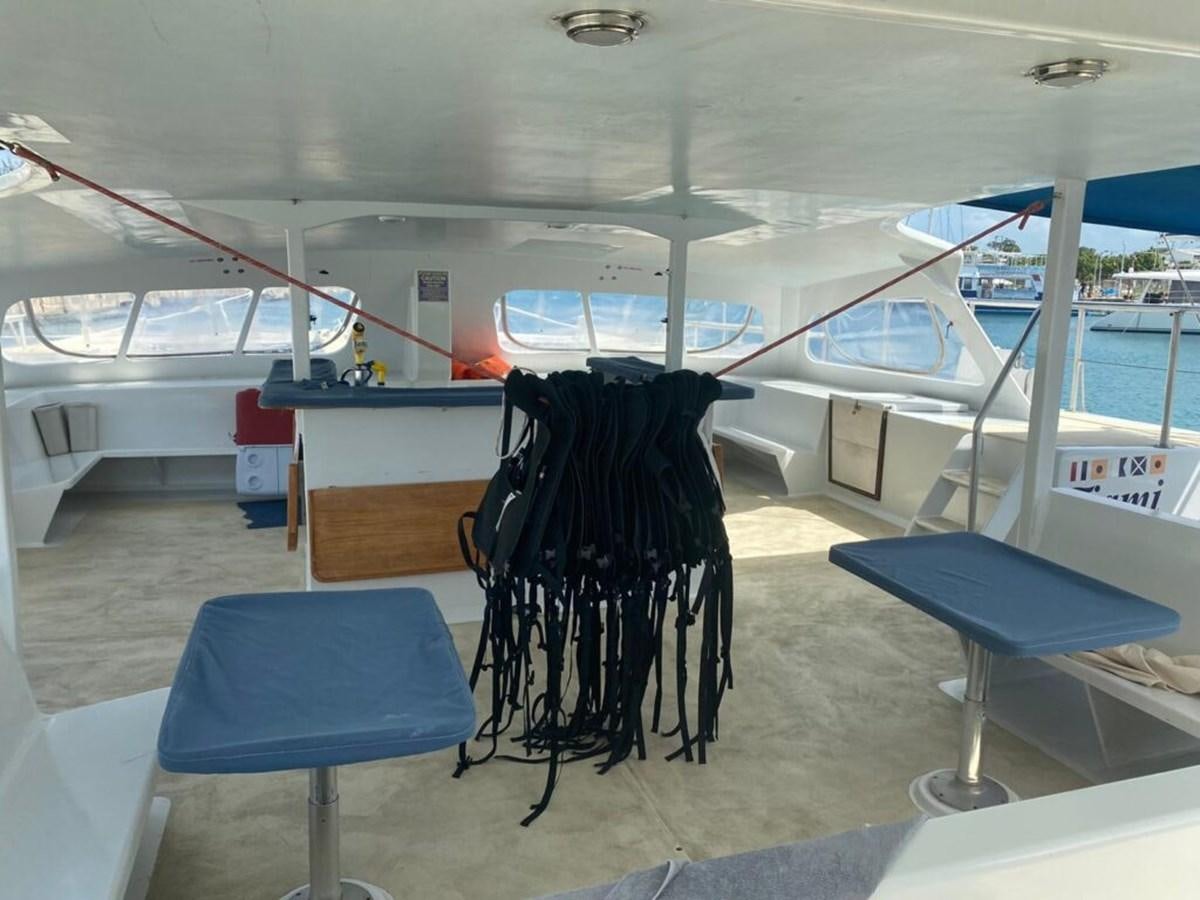 a table and chairs in a room aboard 1996 GOLD COAST GC 70 Yacht for Sale