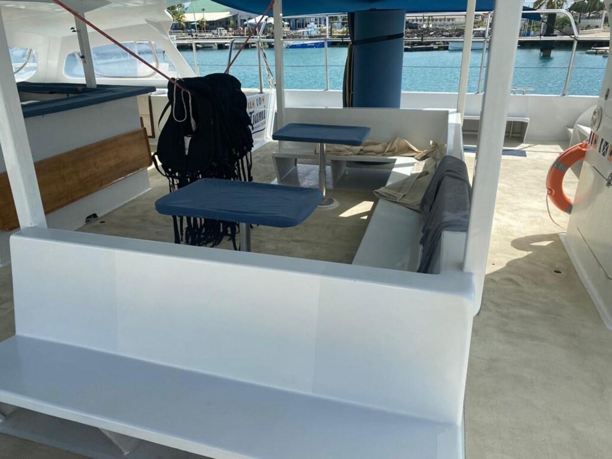 a boat with a seat and a seat on the deck aboard 1996 GOLD COAST GC 70 Yacht for Sale