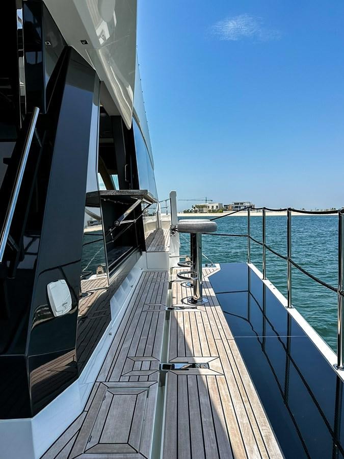 a deck with a railing and a railing with a body of water in the background aboard JANICE Yacht for Sale