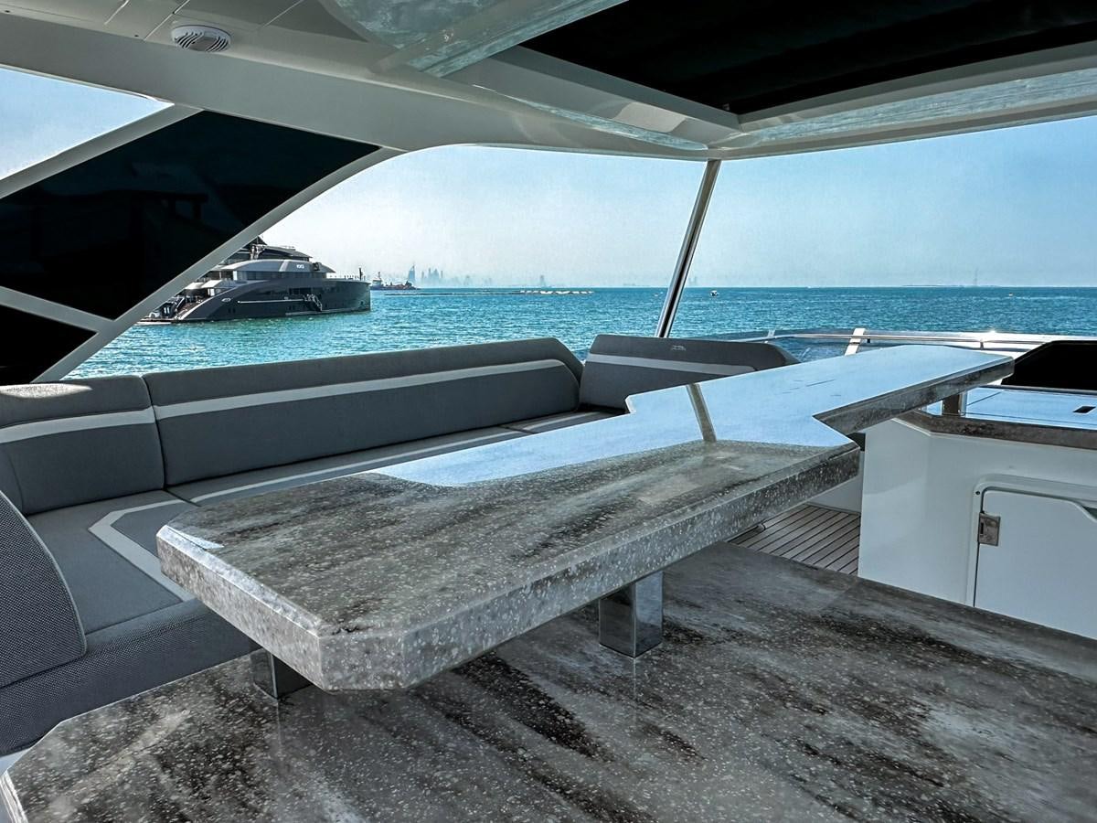 a pool with a deck and a boat in the background aboard JANICE Yacht for Sale