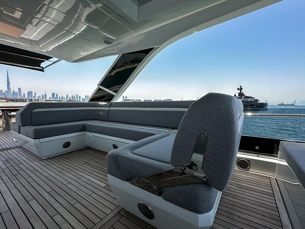 a deck with a chair and a boat on it aboard JANICE Yacht for Sale
