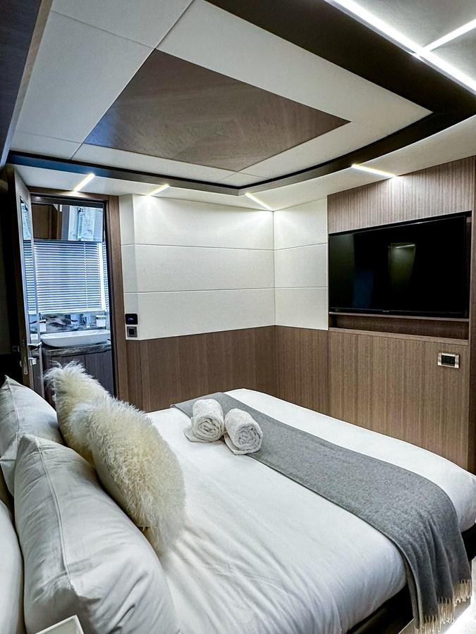 a bedroom with a bed and a television aboard JANICE Yacht for Sale