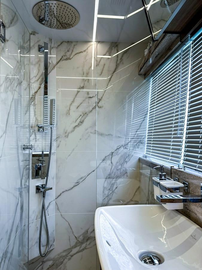 a bathroom with a shower and sink aboard JANICE Yacht for Sale