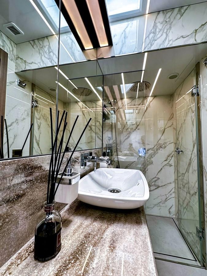 a bathroom with a glass shower aboard JANICE Yacht for Sale