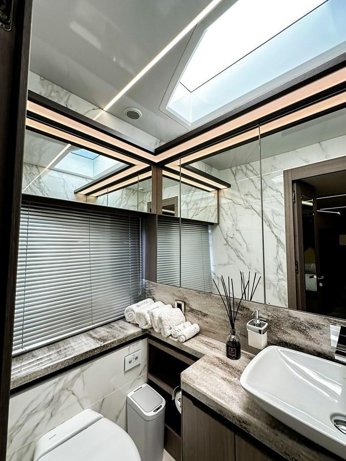 a bathroom with a large window aboard JANICE Yacht for Sale