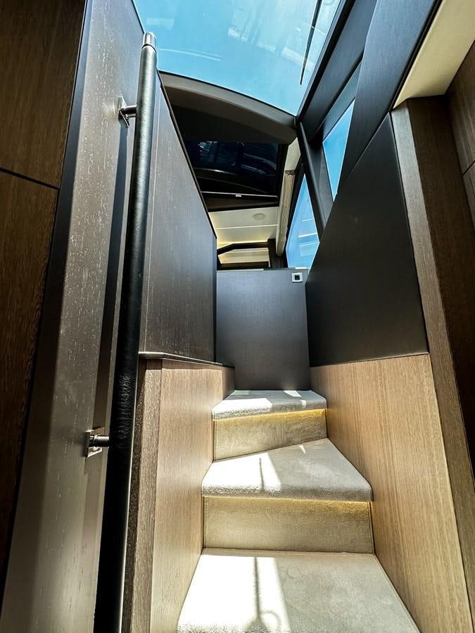 a staircase with a metal railing aboard JANICE Yacht for Sale