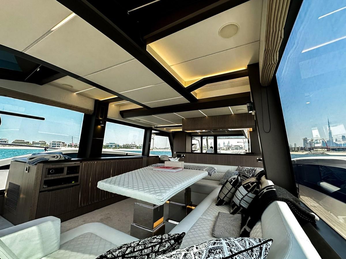 inside of a vehicle with a table and a tv on the wall aboard JANICE Yacht for Sale