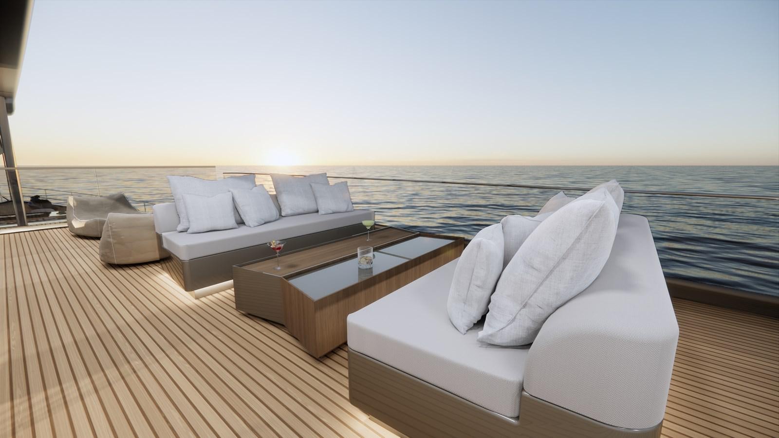 a couch and a table on a deck overlooking a body of water aboard BOA KINGDOM Yacht for Sale