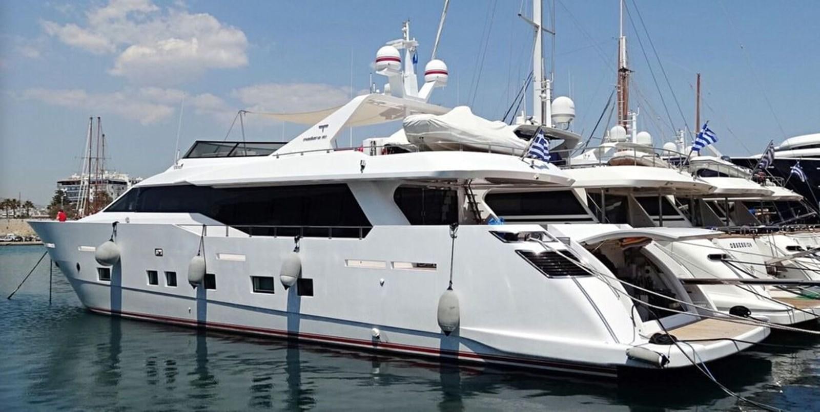 a white yacht in a harbor aboard AURORA Yacht for Sale