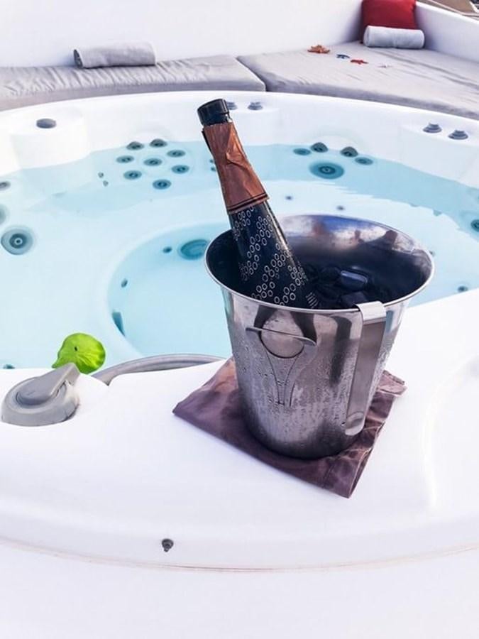 a bottle of liquor on a table aboard AURORA Yacht for Sale