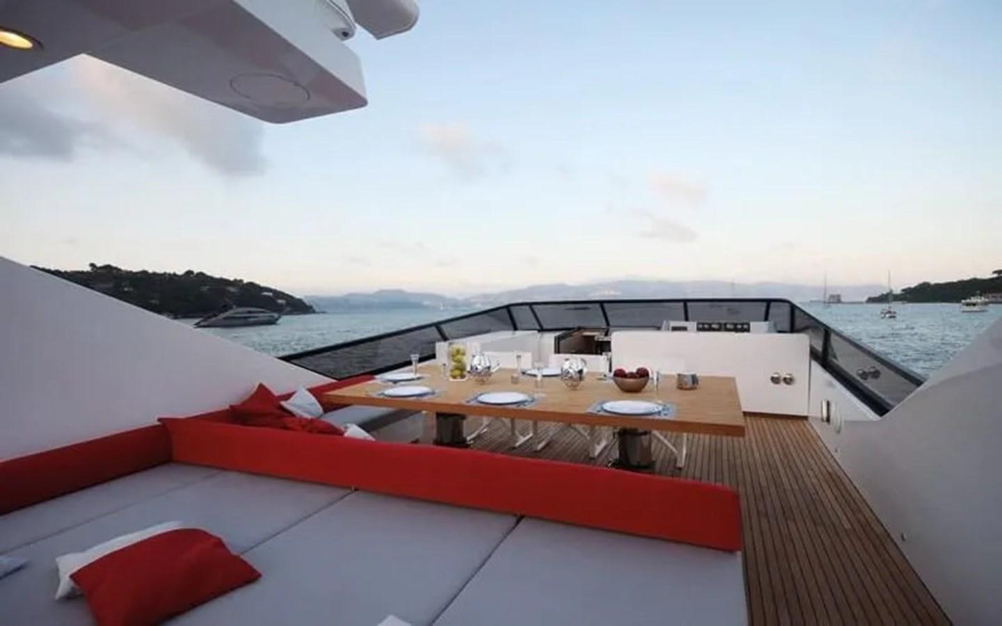 a deck with a table and chairs on it aboard AURORA Yacht for Sale
