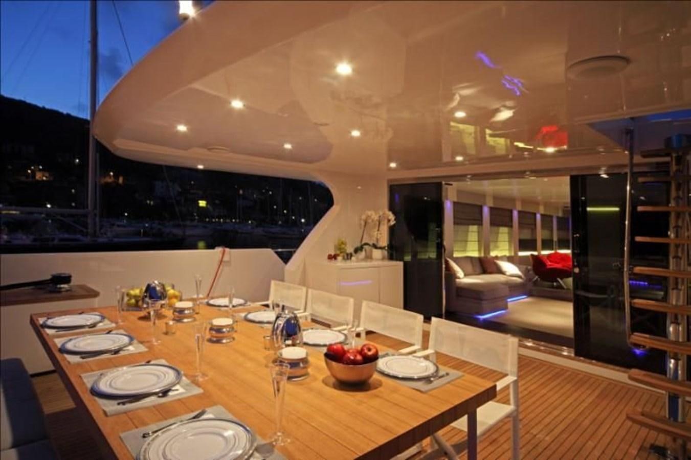 a large kitchen with a table and chairs aboard AURORA Yacht for Sale