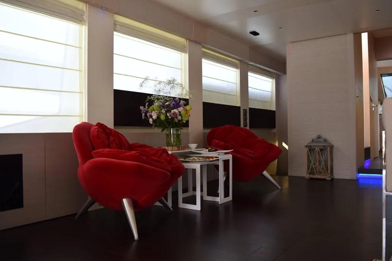 a couple red chairs in a room aboard AURORA Yacht for Sale