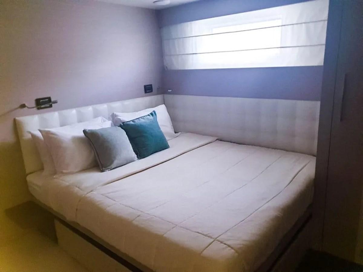 a bed with white sheets aboard AURORA Yacht for Sale