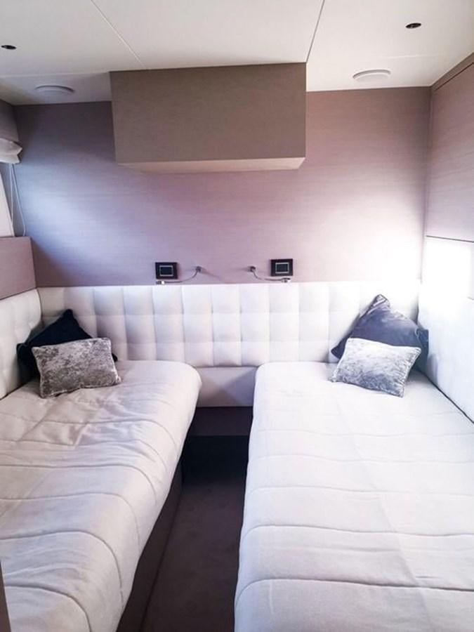 a room with a couple of beds aboard AURORA Yacht for Sale