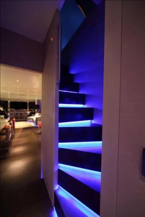 a room with a blue staircase aboard AURORA Yacht for Sale