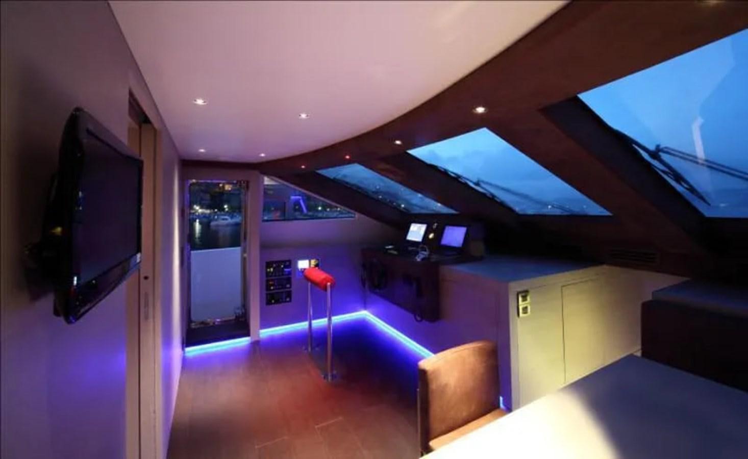 a room with a tv and a table aboard AURORA Yacht for Sale