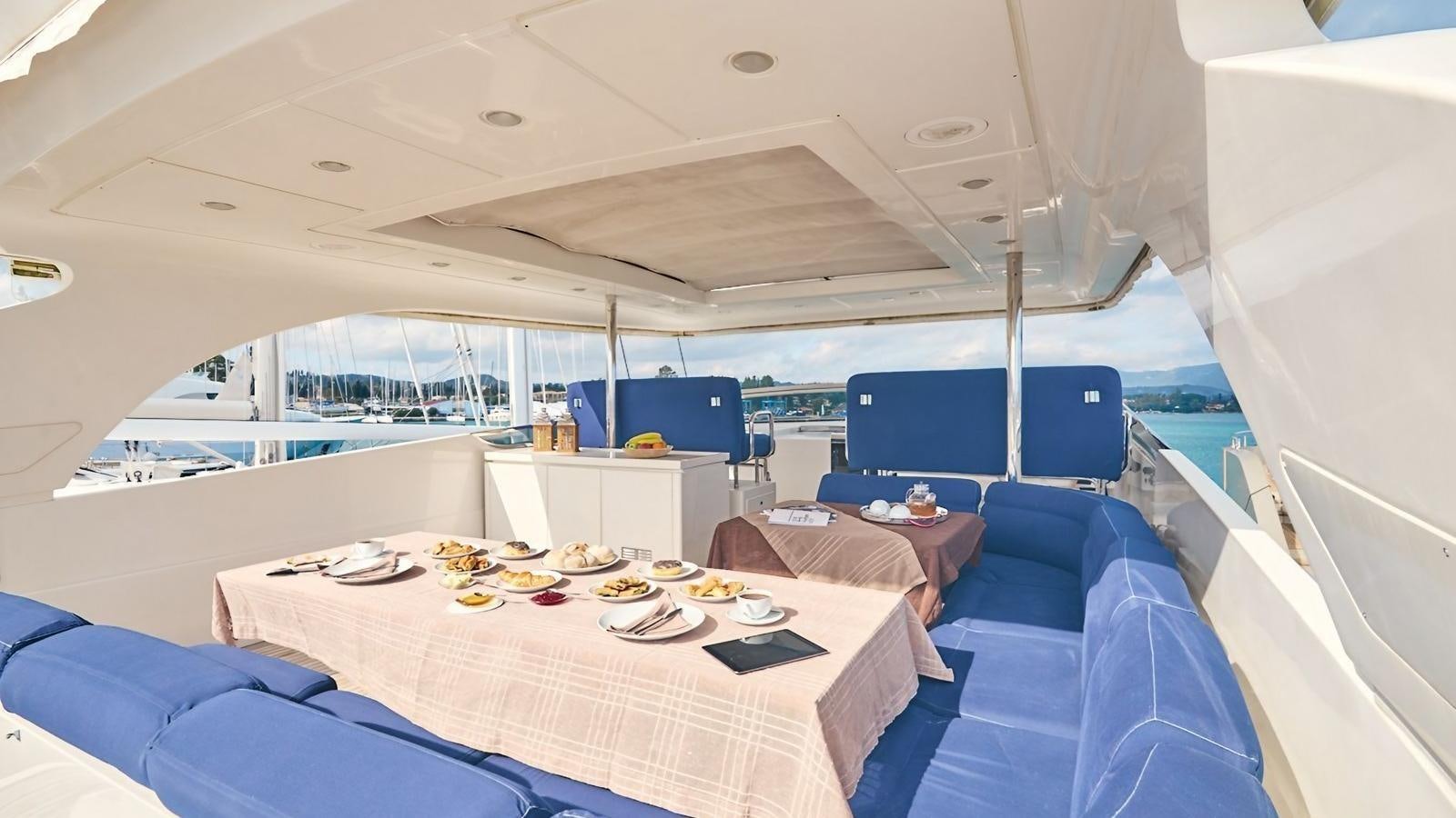 a large white tent with a table and chairs and a table with food on it aboard SUNRAY II Yacht for Sale